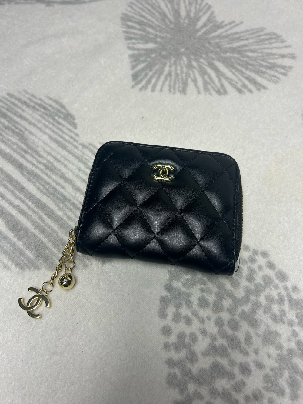 Black quilted puff bifold wallet with gold hardware
